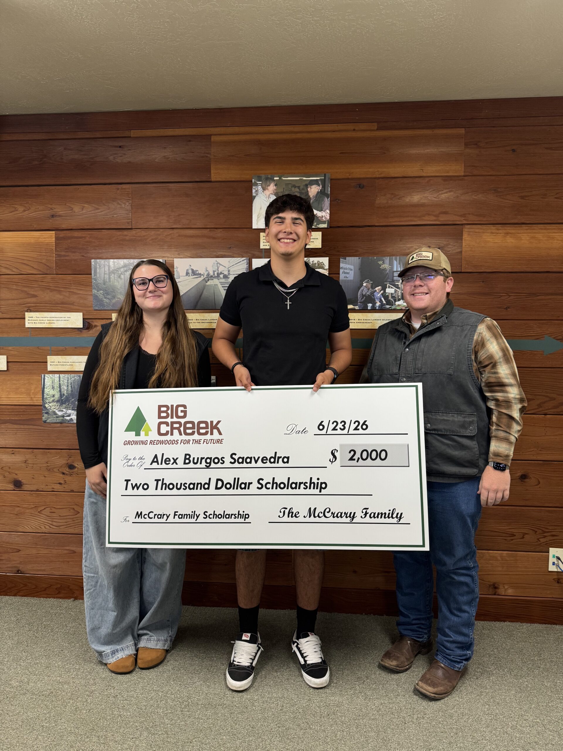 Group of students holding a big check