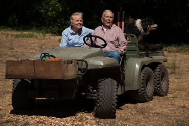 Lud and his wife and dog in a 6 wheel vehicle.