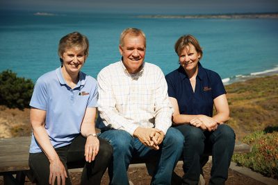 Ellen, Ken, and Janet sitting outdoors.