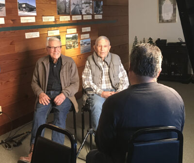 Two older gentlemen being interviewed