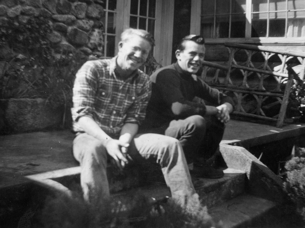Two men sitting on a deck in the 1946