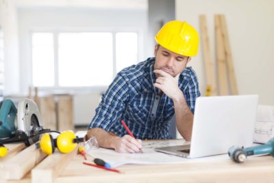Contractor sitting at a table on a laptop