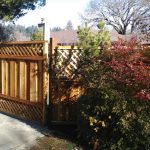 Street view of redwood fence gate.