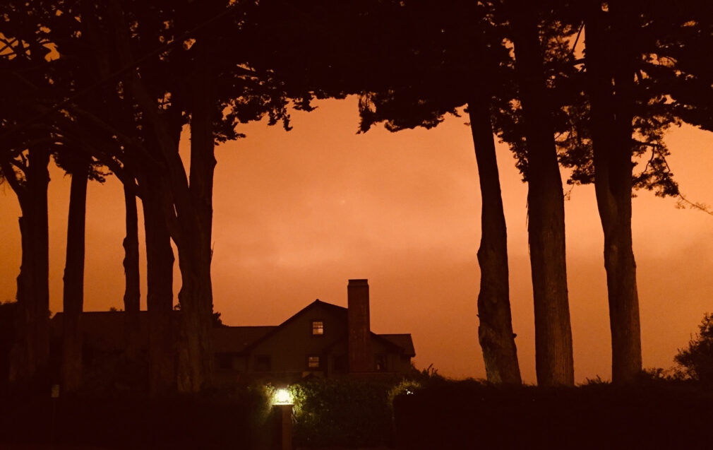 Home with eerie sunset behind it