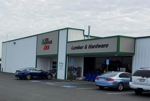 Photo of the store front of a Big Creek Lumber and Ace Hardware with cars out front