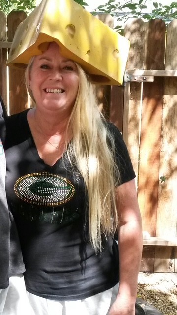 Woman with cheese head hat on