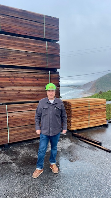 Man in front of lumber
