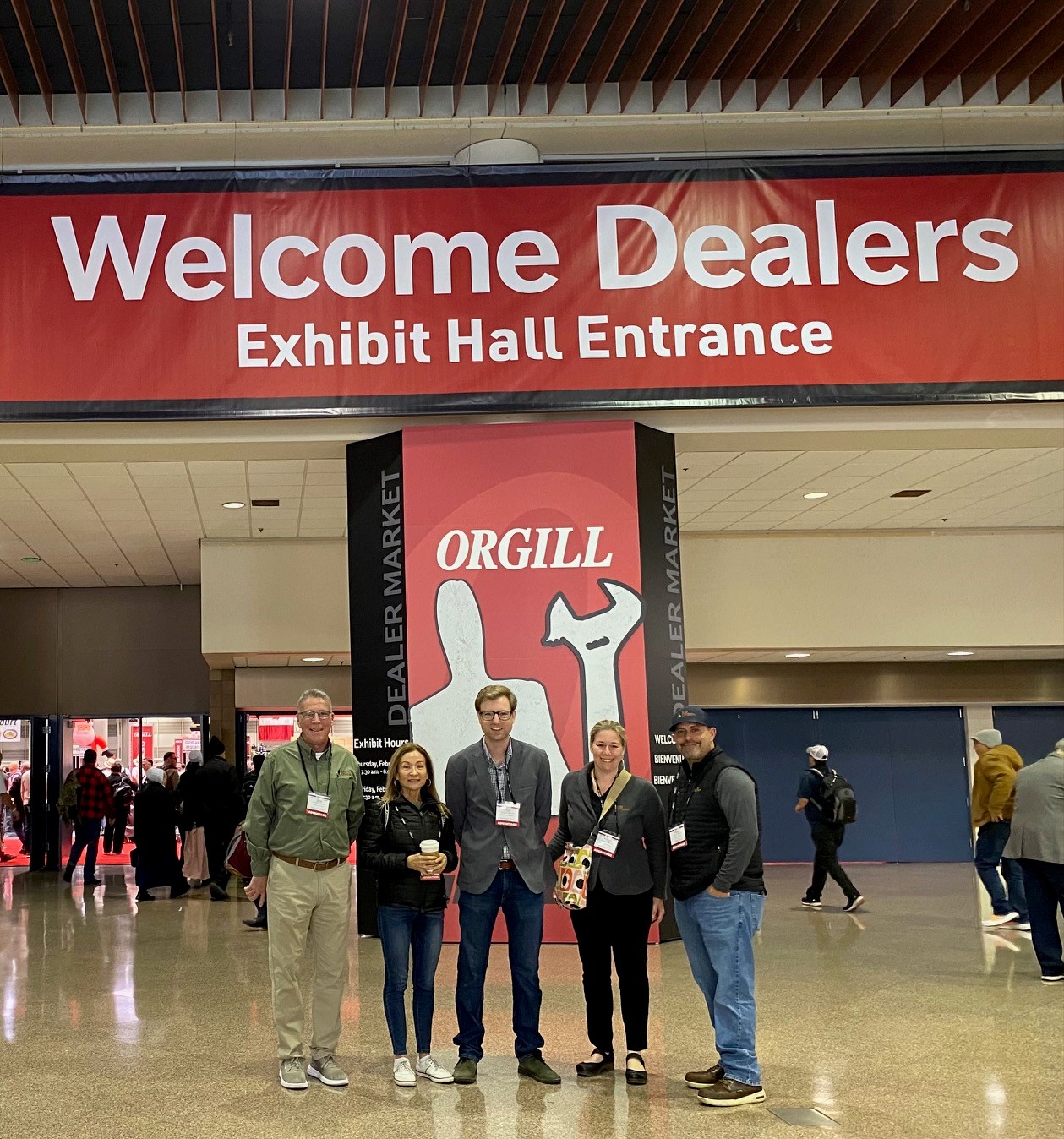 People standing together at entrance to a trade show