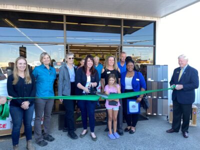 Group posing while doing a ribbon cutting in front of Big Creek's new location in Vallejo 
