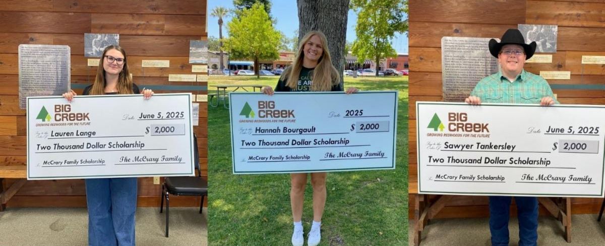 Scholarship recipients holding their checks