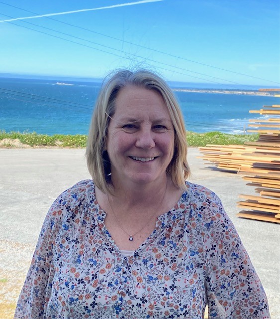Woman smiling with ocean in the Background