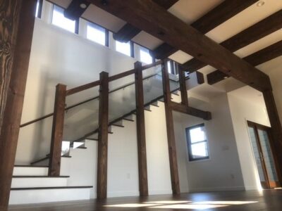 Staircase with wood beams and white walls