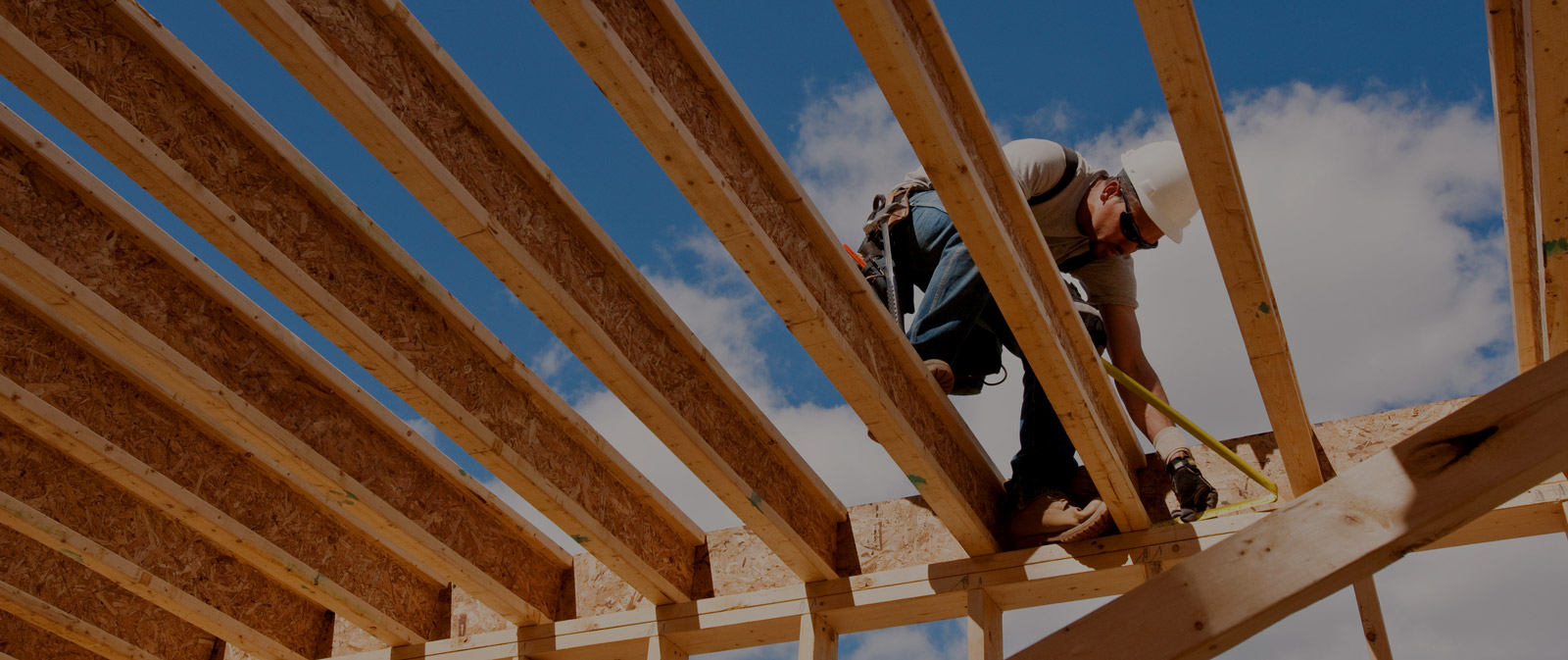 Construction worker installing joists.