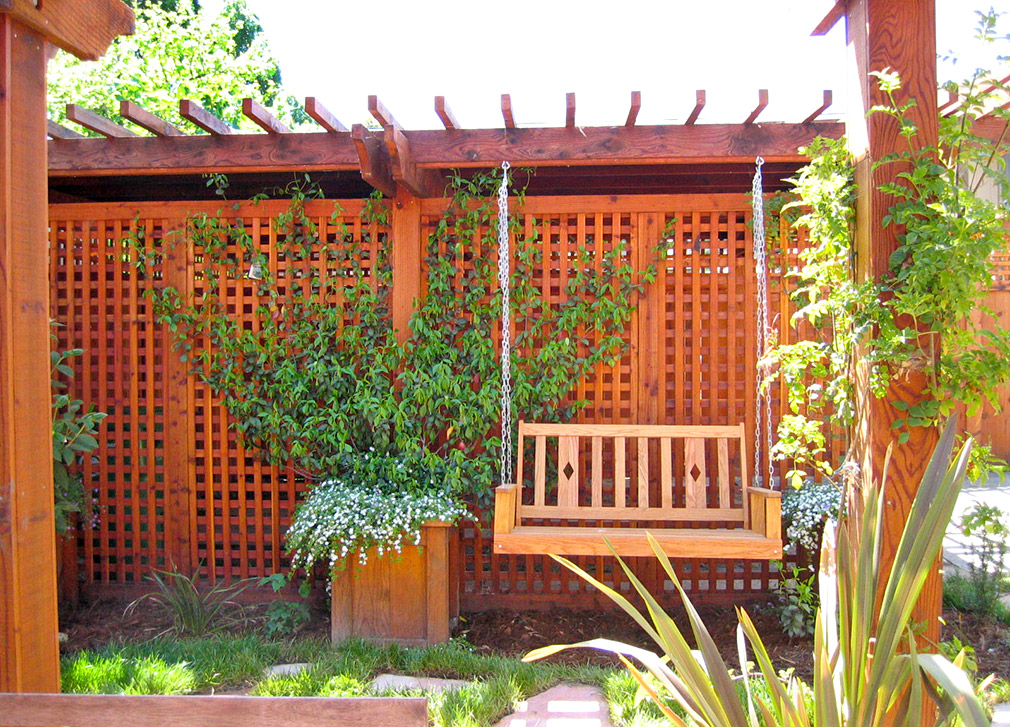 Back yard porch swing with lattice panels.